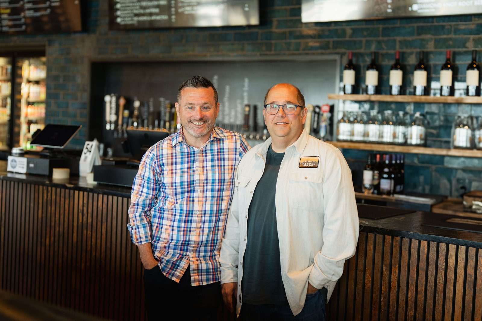 Sean Drought and Vince Rossetti standing together at the Tapped Public House bar